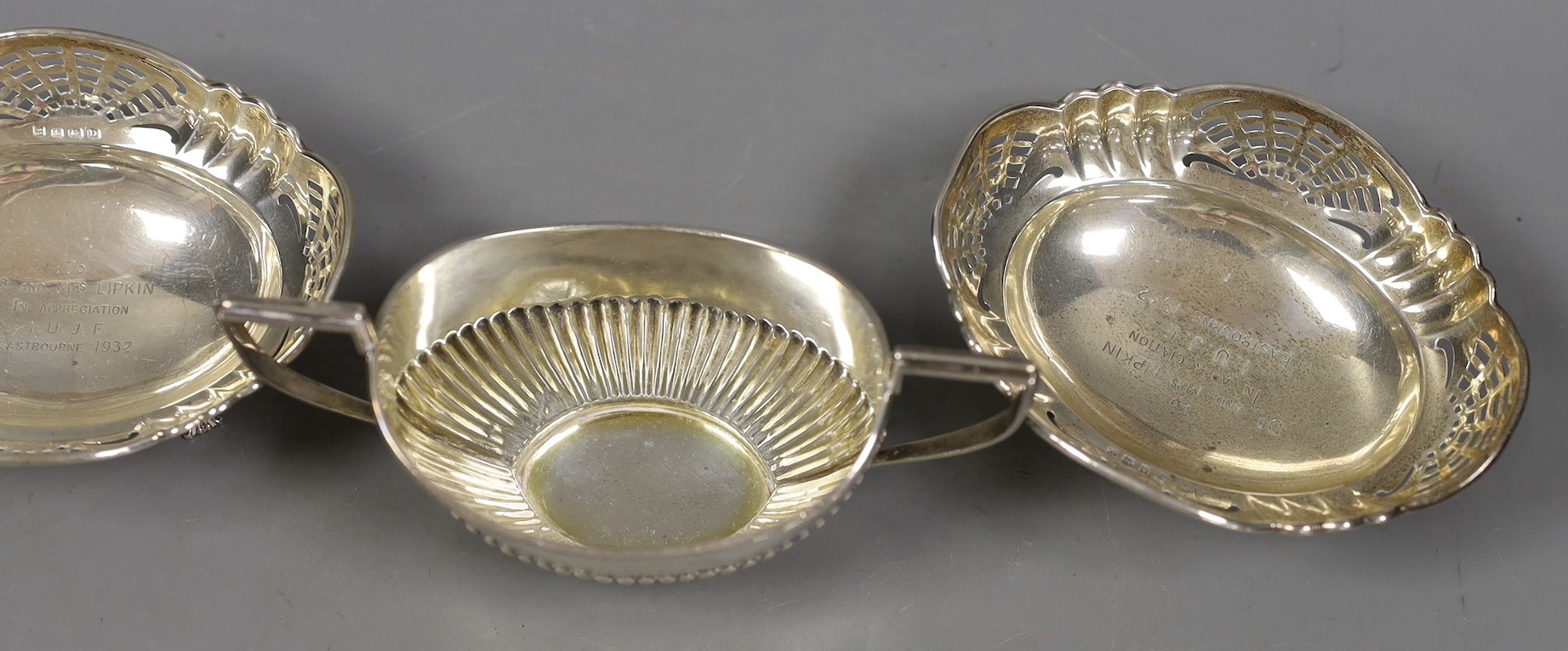 A George V demi fluted silver cream jug and sugar bowl, Birmingham, 1911 and a pair of pierced silver bonbon dishes, Birmingham, 1928, 8oz.